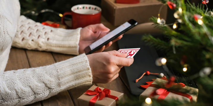 shopping-online-during-holidays-woman-uses-phone-credit-card-orders-christmas-gifts_EDIT-1