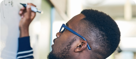 Man writing on white board