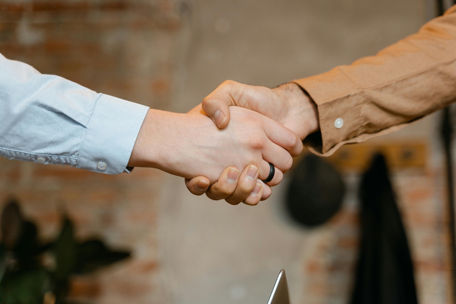 Close-up of two colleagues shaking hands in an office
